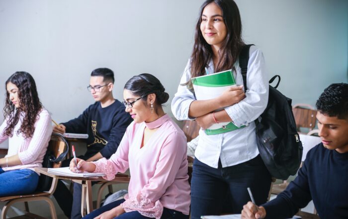 Student smiling and holding books