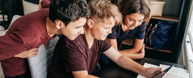 Three young people looking at a tablet together